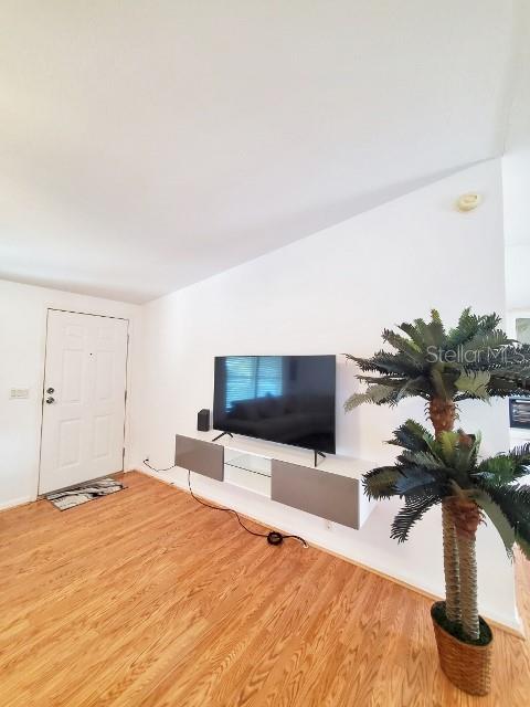 29200 South Jones Loop Road, Unit 125 Punta Gorda, FL 33950 - Photo 7 of 52 a bedroom with furniture and flat screen tv