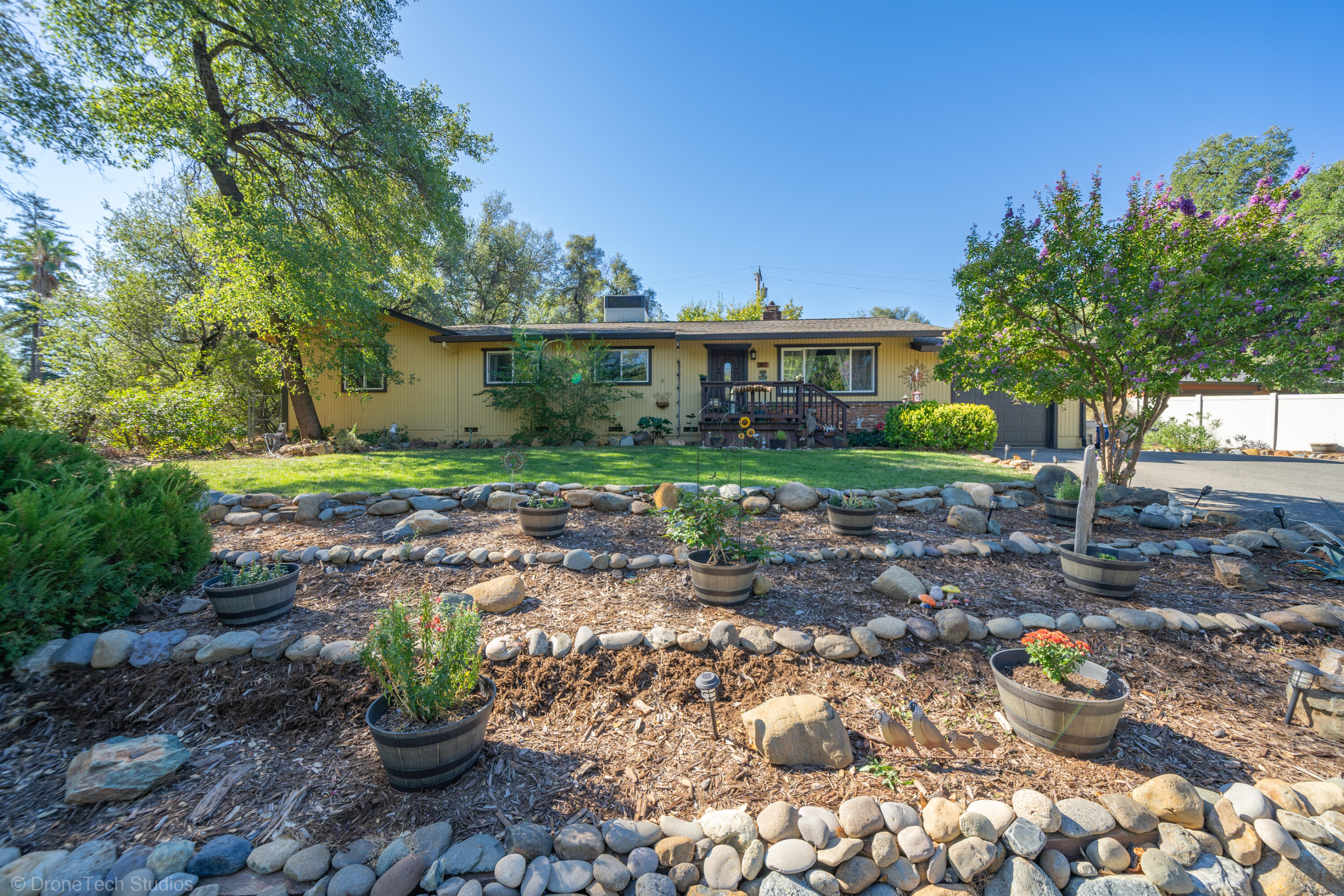 3059 Quartz Hill Road Redding, CA 96003 - Photo 1 of 64 a view of a house with a yard and potted plants