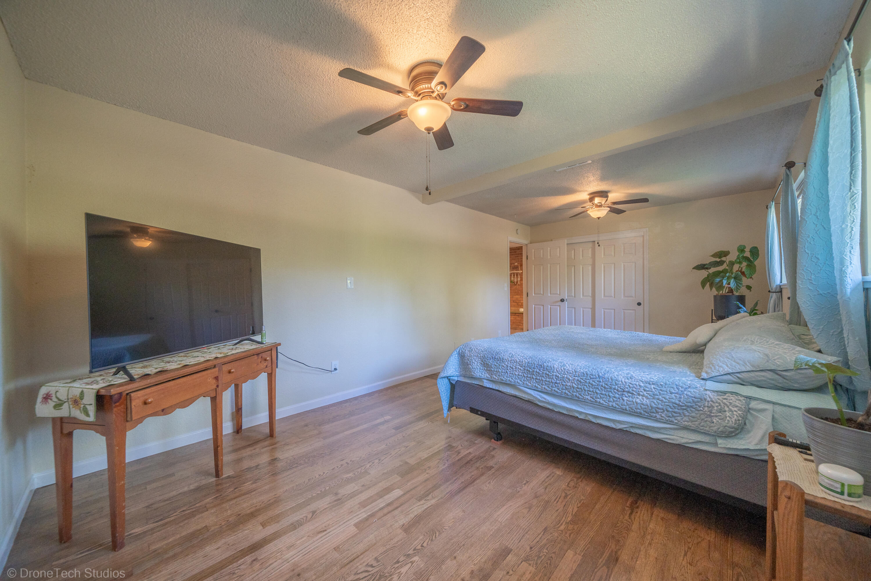 3059 Quartz Hill Road Redding, CA 96003 - Photo 23 of 64 a bedroom with a bed and a flat screen tv