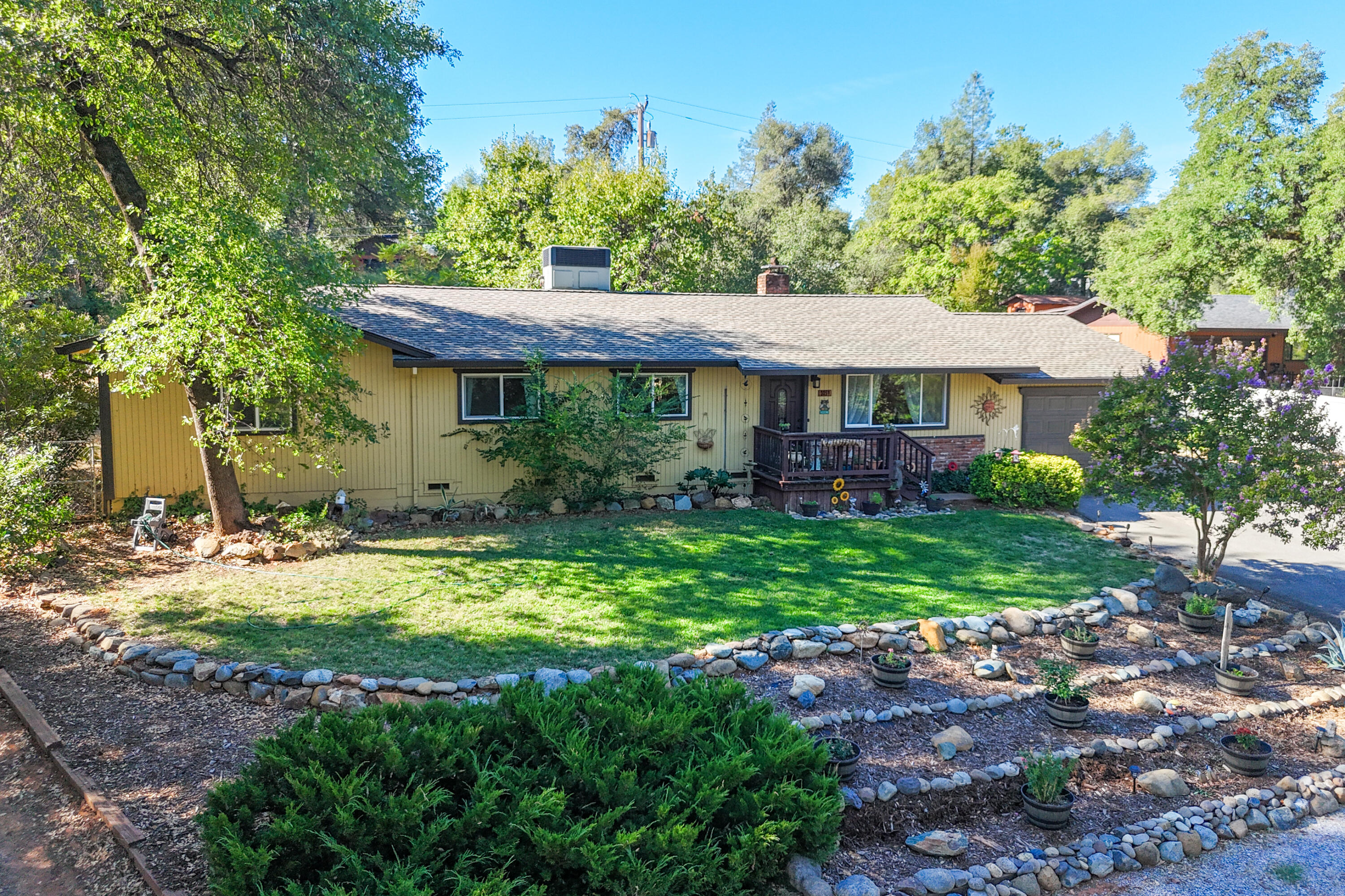 3059 Quartz Hill Road Redding, CA 96003 - Photo 32 of 64 a view of a house with a yard potted plants and large tree