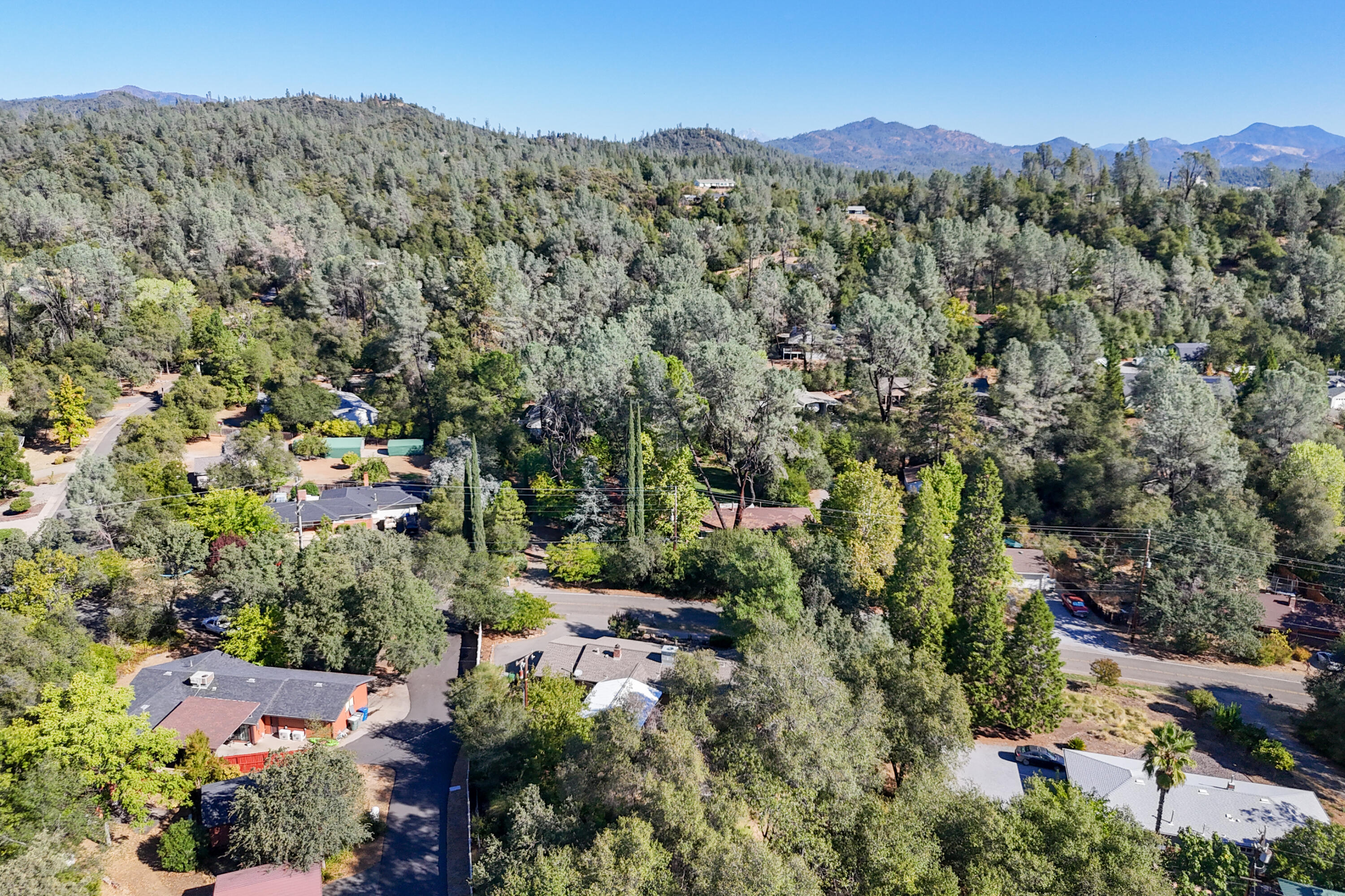 3059 Quartz Hill Road Redding, CA 96003 - Photo 40 of 64 an aerial view of a houses with a lush green hillside