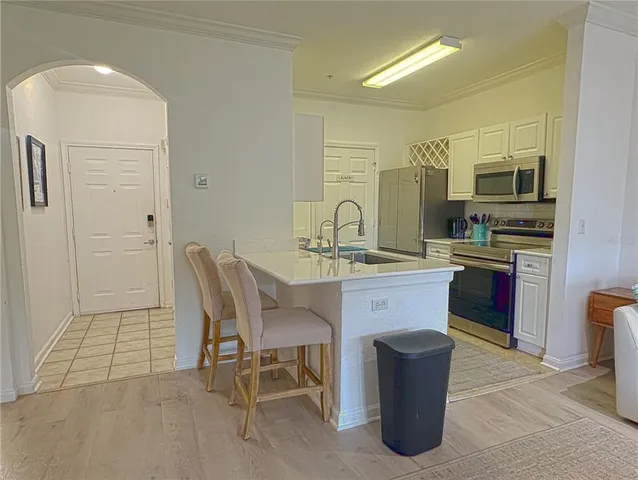 a kitchen with a sink cabinets and appliances