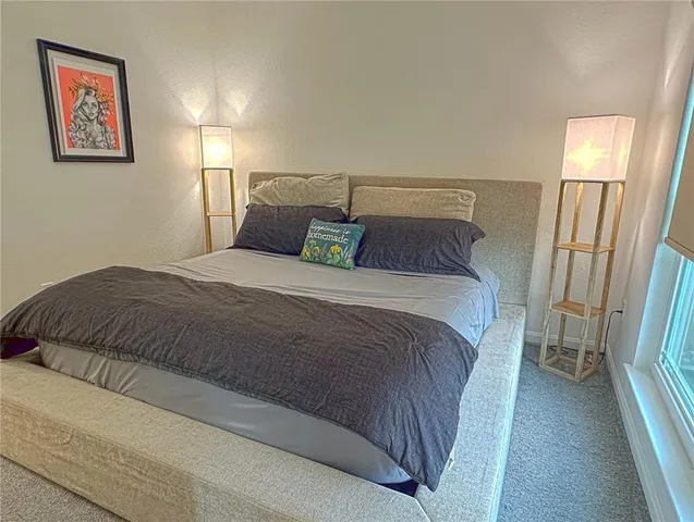 a bedroom with a bed and a mirror