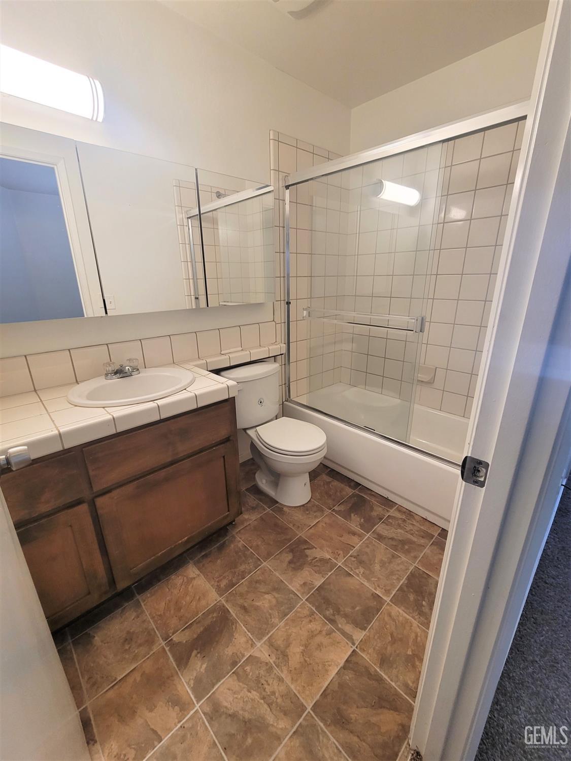 Undisclosed Address Bakersfield, CA 93309 - Photo 7 of 8 a bathroom with a double vanity sink toilet and shower