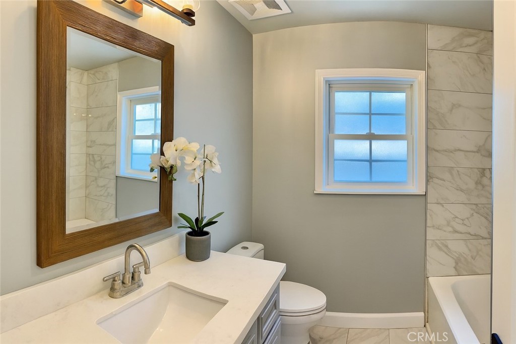 2108 La Paloma Avenue Alhambra, CA 91803 - Photo 11 of 15 a bathroom with a sink a toilet and a mirror