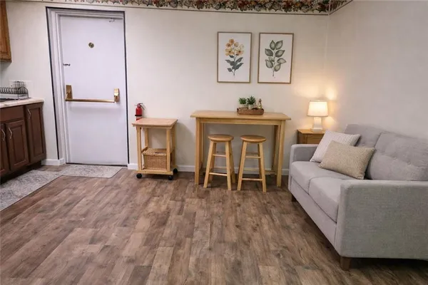 a living room with furniture and a wooden floor