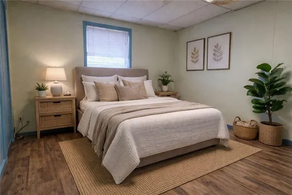 a bedroom with a bed and a potted plant