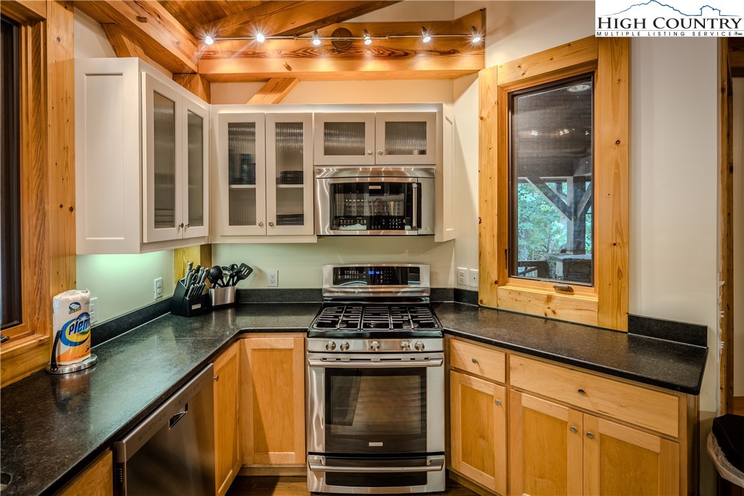 161 Hump View Trail Banner Elk, NC 28604 - Photo 35 of 50 a kitchen with stainless steel appliances granite countertop a stove and a microwave