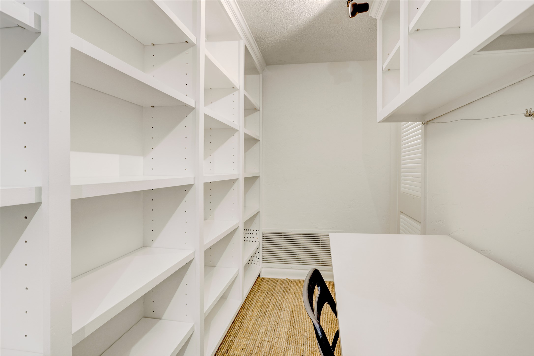 2701 Westheimer Road, Unit 2D Houston, TX 77098 - Photo 19 of 48 An alternate view of the library or study showcases the extensive built-in shelving, ideal for books, display, files, and organized storage.