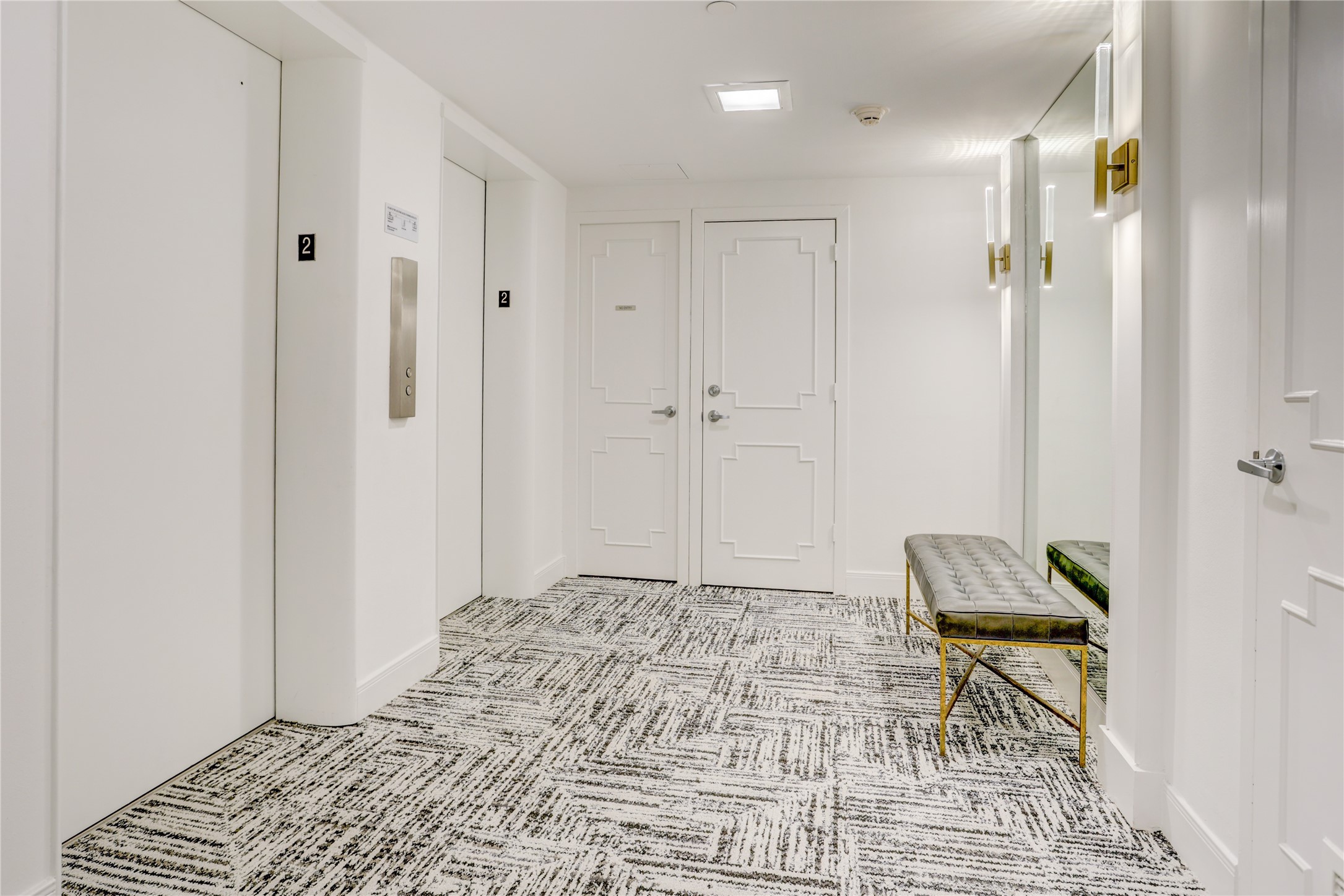 2701 Westheimer Road, Unit 2D Houston, TX 77098 - Photo 30 of 48 A quiet elevator hallway with secondary unit entrance on the right and primary front entry located further down the corridor.