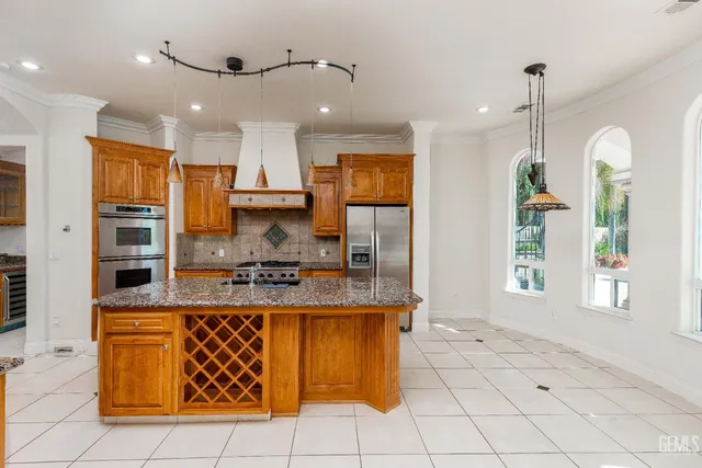 a kitchen with stainless steel appliances a stove a sink and a refrigerator