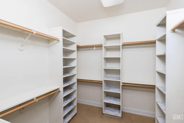 a view of a room with large windows and plants