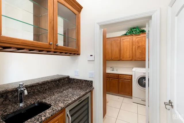 a view of a swimming pool with a lawn chairs and palm trees
