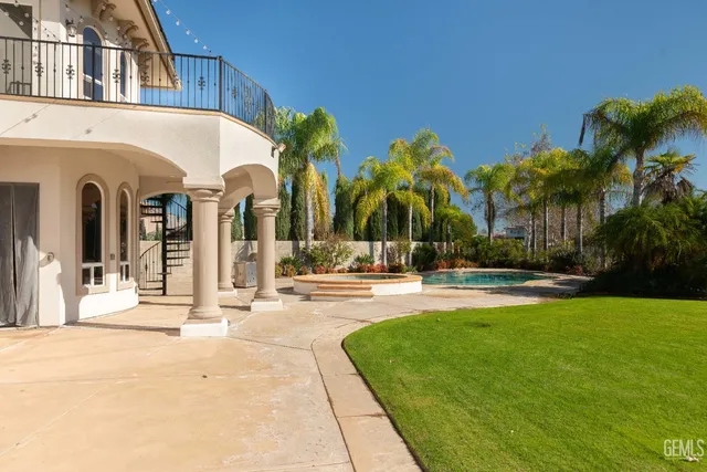 a view of a swimming pool with a yard