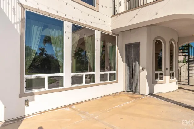 a view of a swimming pool with a patio and a yard