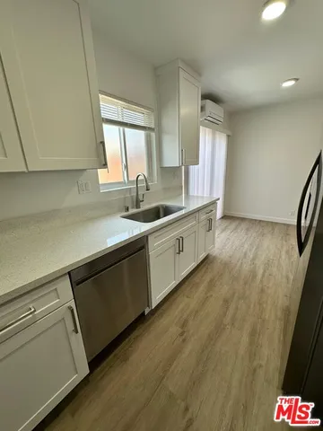 a kitchen with stainless steel appliances granite countertop a sink stove and cabinets