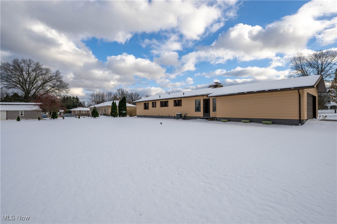 View of snow covered rear of property