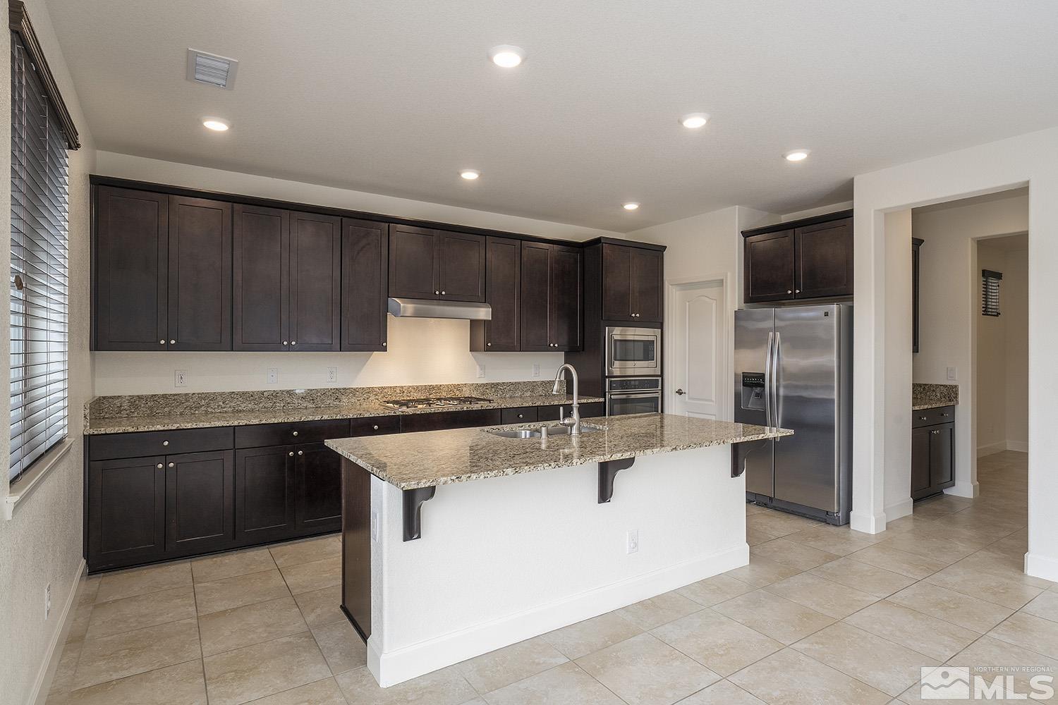 1675 Scott Valley Road Reno, NV 89523 - Photo 11 of 40 a kitchen with stainless steel appliances granite countertop a stove and a refrigerator