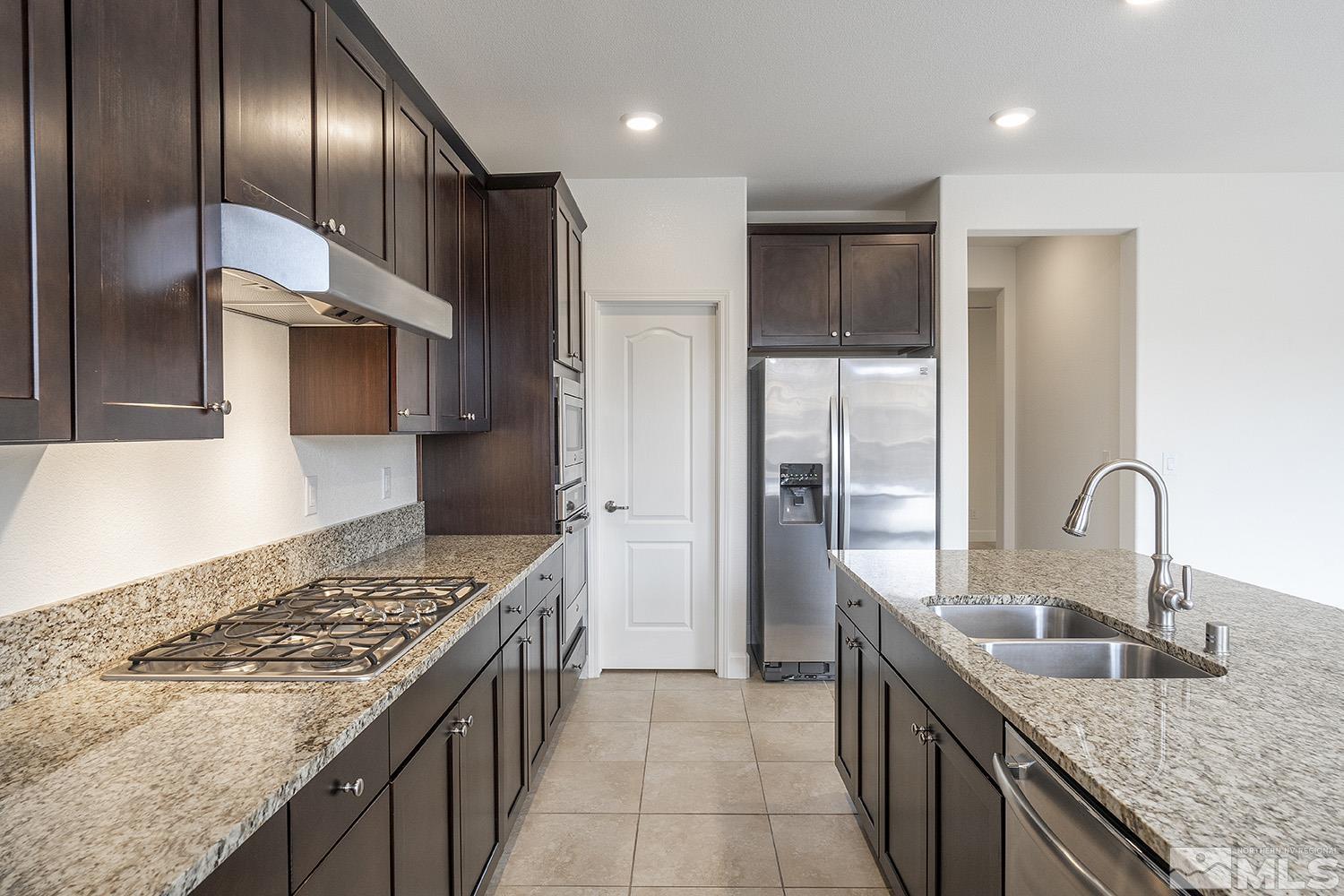 1675 Scott Valley Road Reno, NV 89523 - Photo 13 of 40 a kitchen with stainless steel appliances granite countertop a sink stove and refrigerator
