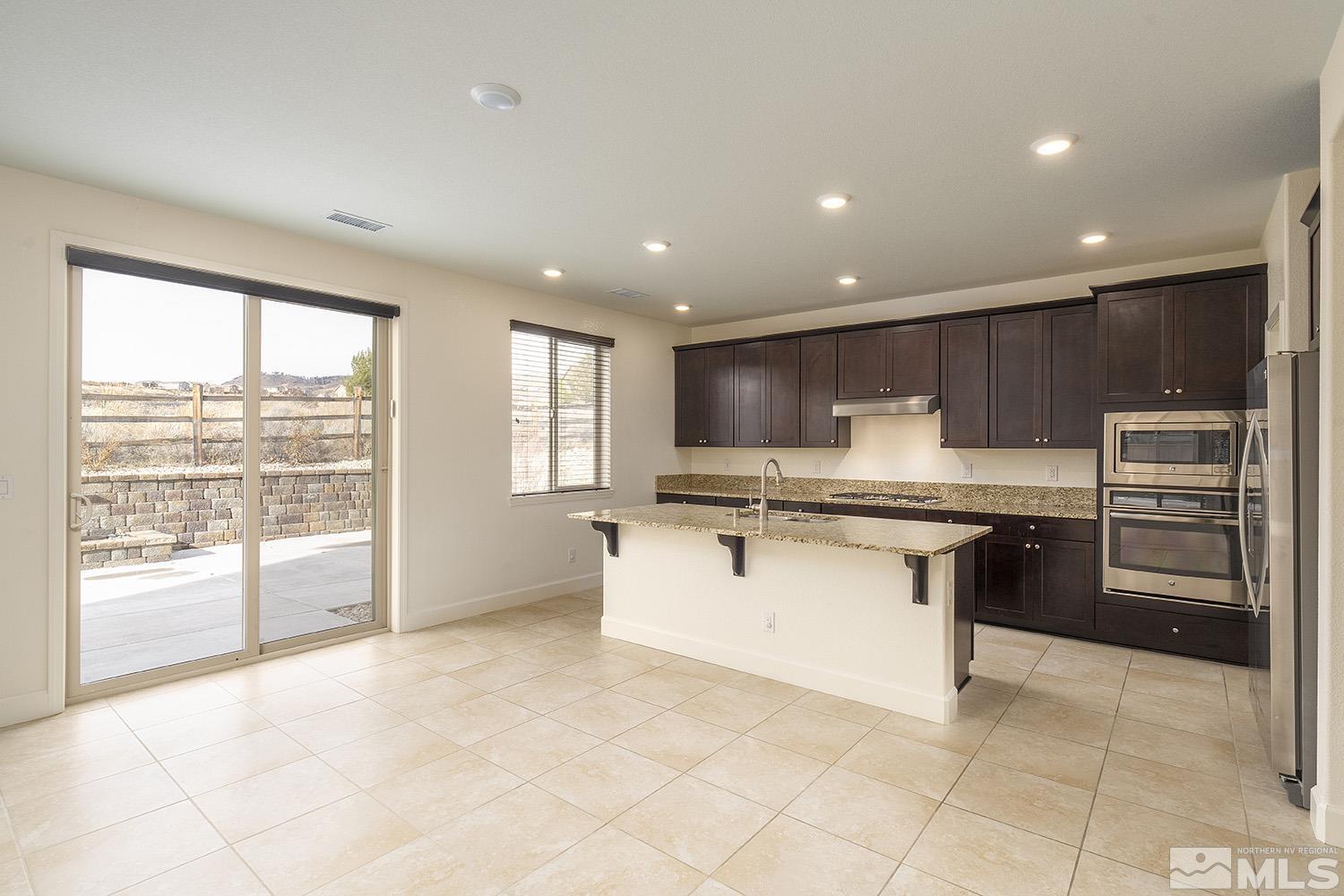 1675 Scott Valley Road Reno, NV 89523 - Photo 14 of 40 a kitchen with stainless steel appliances granite countertop a stove and a refrigerator