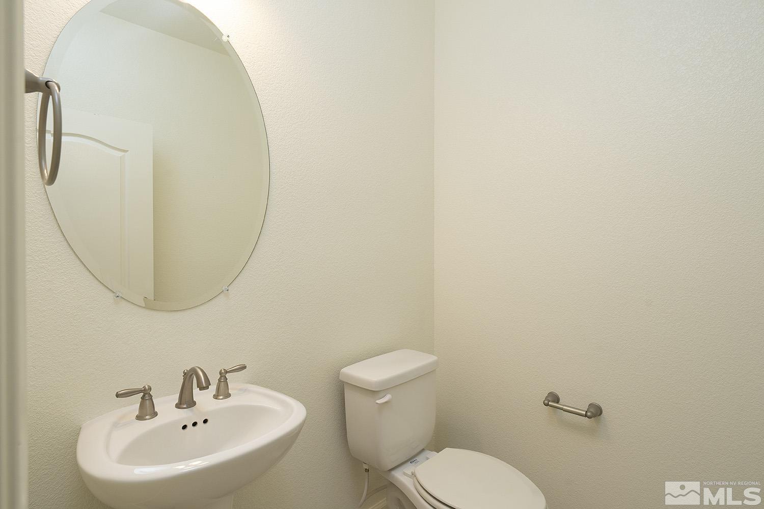 1675 Scott Valley Road Reno, NV 89523 - Photo 17 of 40 a bathroom with a toilet a sink and mirror