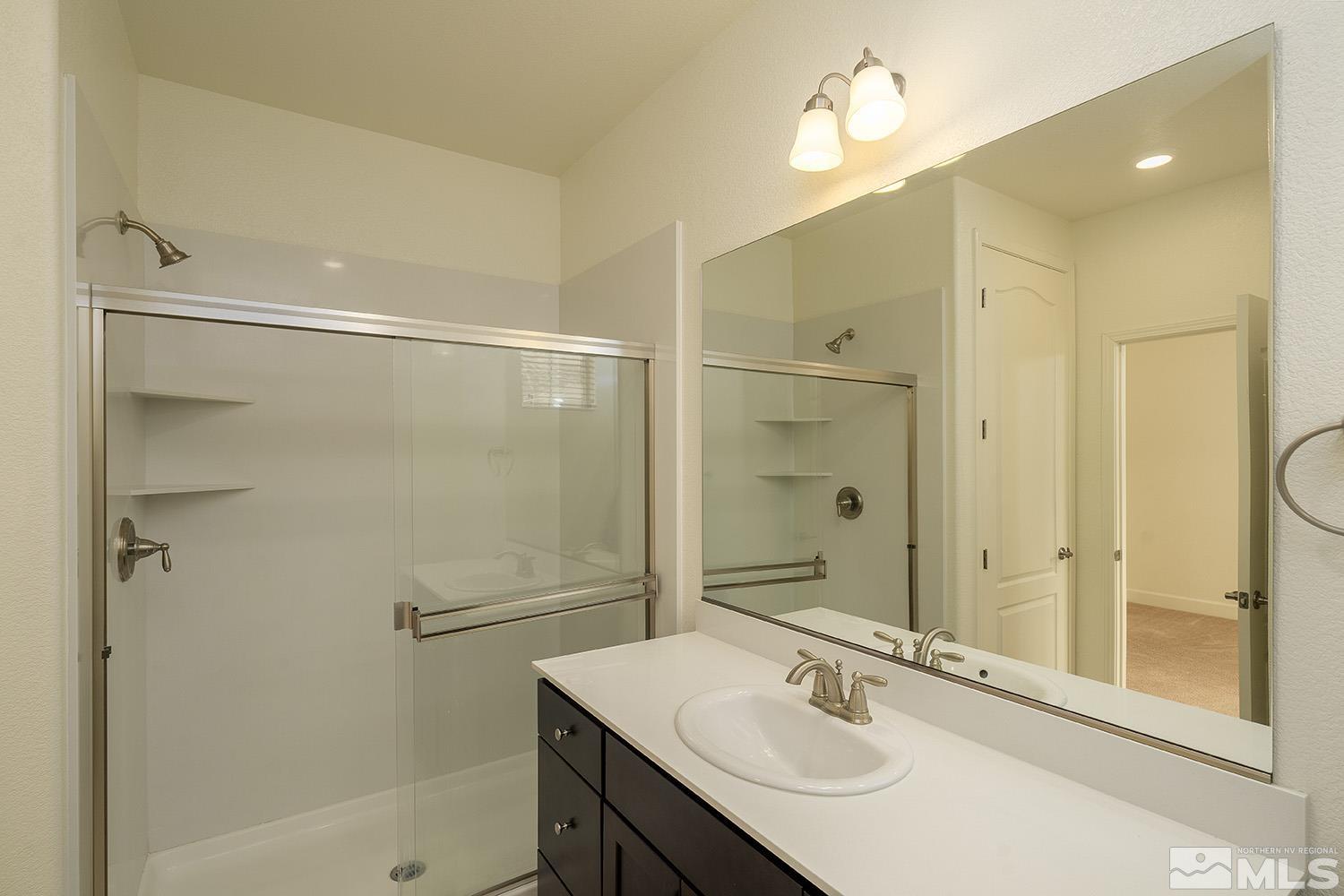 1675 Scott Valley Road Reno, NV 89523 - Photo 30 of 40 a bathroom with a sink shower and a mirror