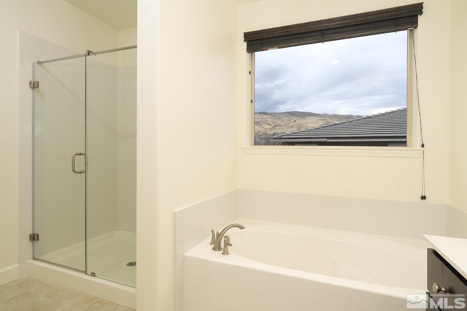 1675 Scott Valley Road Reno, NV 89523 - Photo 34 of 40 a bathroom with a bathtub and a shower