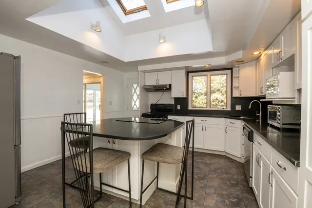 a kitchen with a table chairs stove and microwave