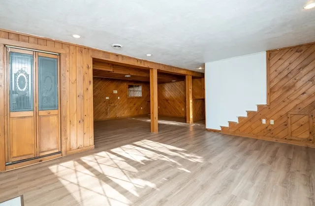 a view of a room with wooden floor and a window