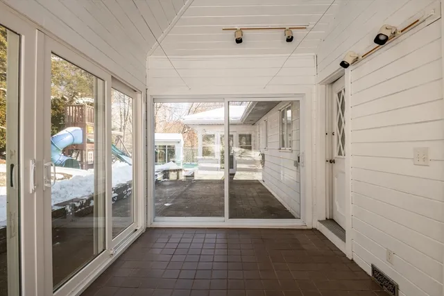 a view of a house with backyard and sitting area
