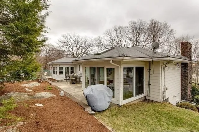a view of backyard with seating area and green space