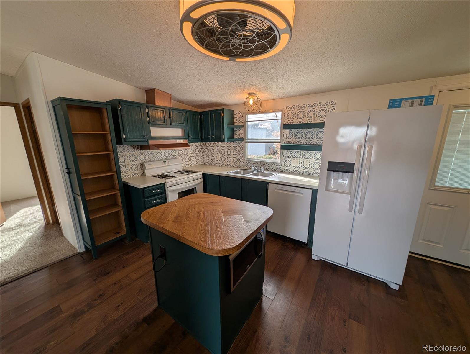 17190 Mt Vernon Road Golden, CO 80401 - Photo 12 of 29 a kitchen with stainless steel appliances granite countertop a refrigerator and a stove top oven