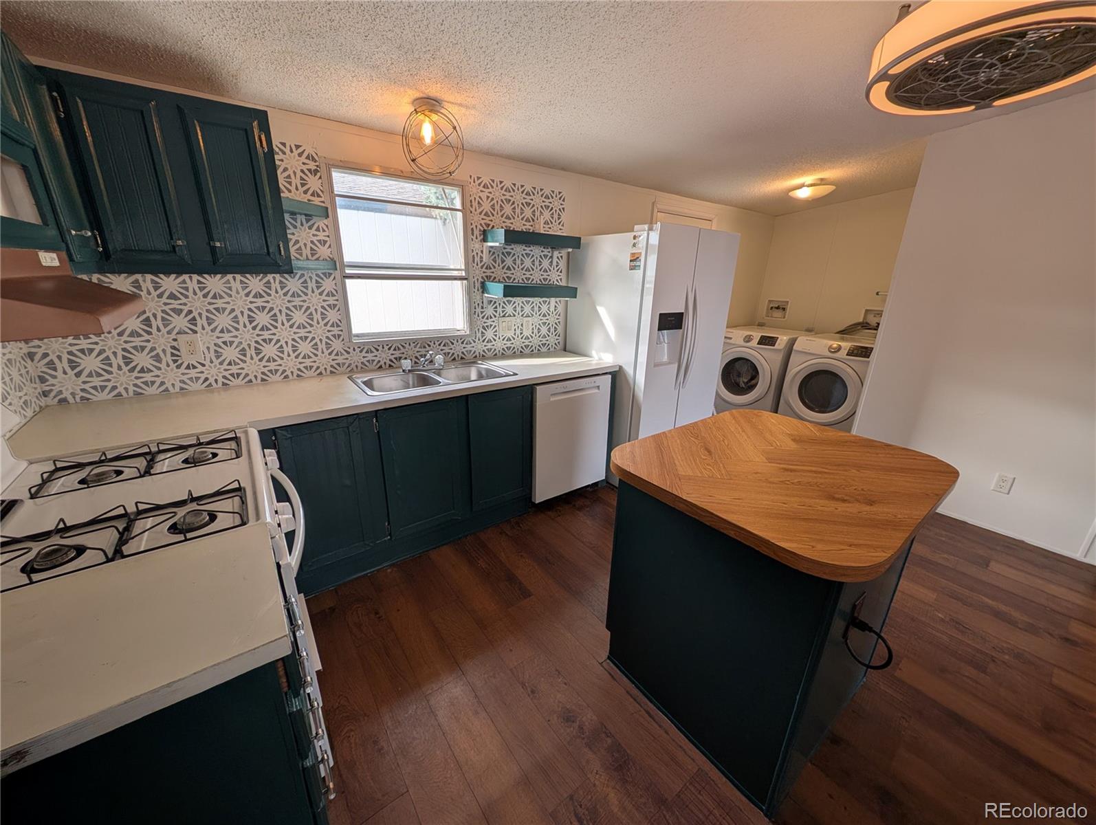 17190 Mt Vernon Road Golden, CO 80401 - Photo 14 of 29 a kitchen with stainless steel appliances sink stove microwave and cabinets