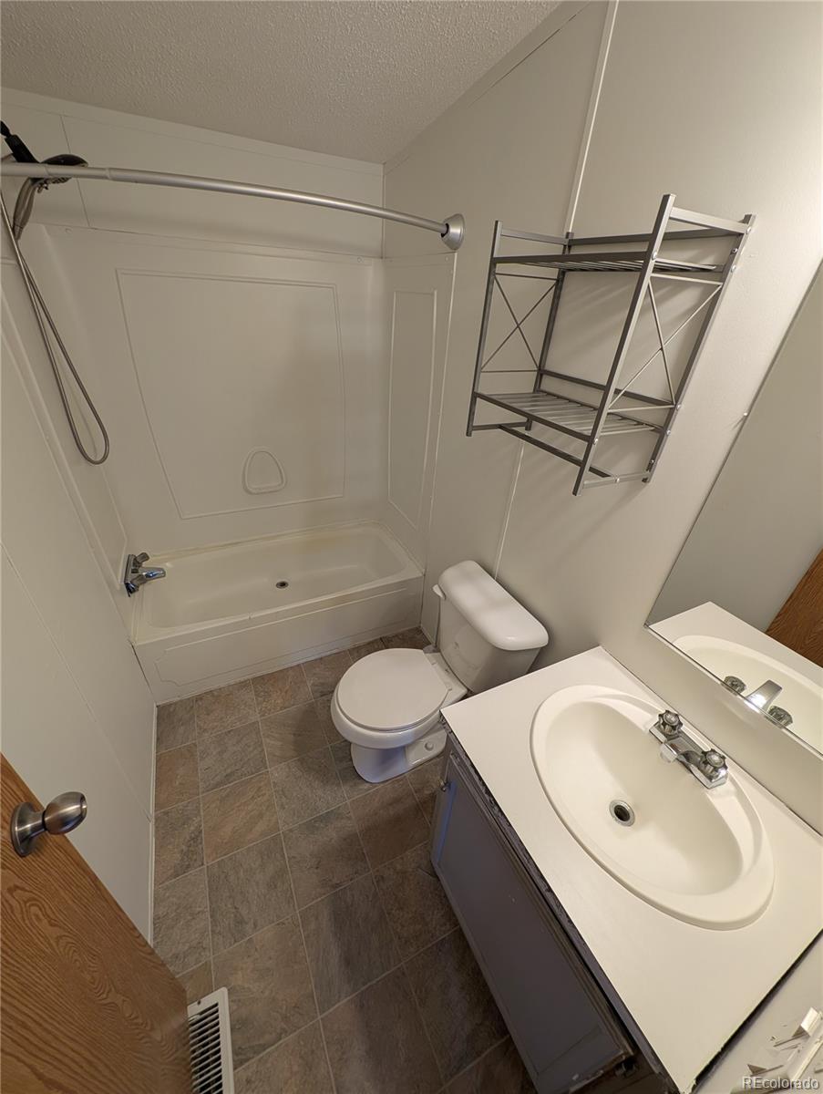 17190 Mt Vernon Road Golden, CO 80401 - Photo 15 of 29 a bathroom with a sink toilet and shower