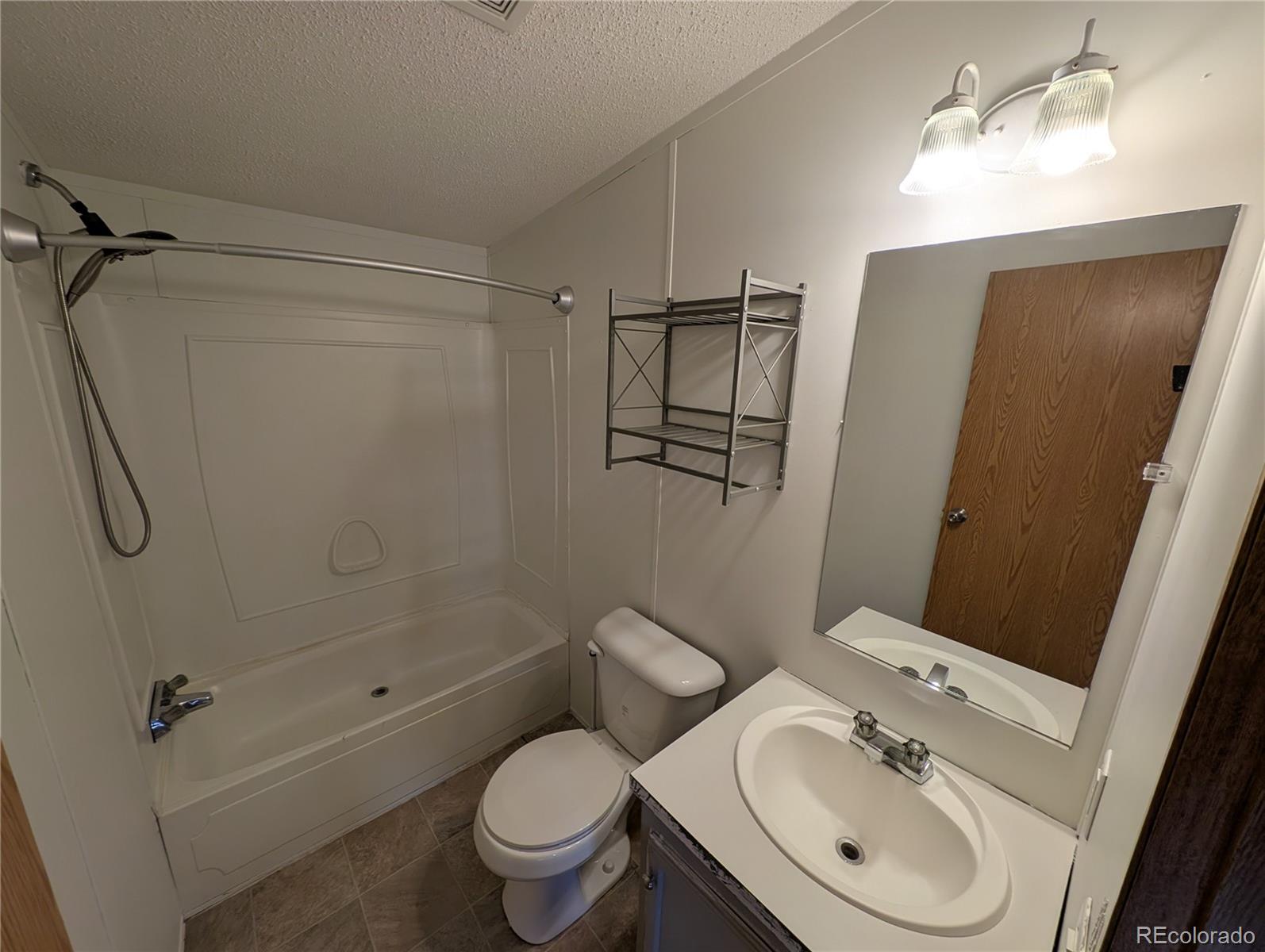 17190 Mt Vernon Road Golden, CO 80401 - Photo 16 of 29 a bathroom with a sink toilet and shower