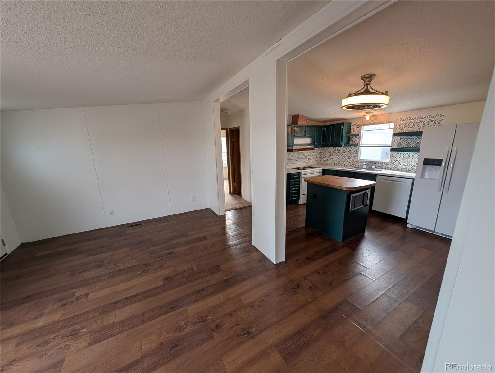 17190 Mt Vernon Road Golden, CO 80401 - Photo 22 of 29 a kitchen with stainless steel appliances granite countertop a stove a sink and a refrigerator