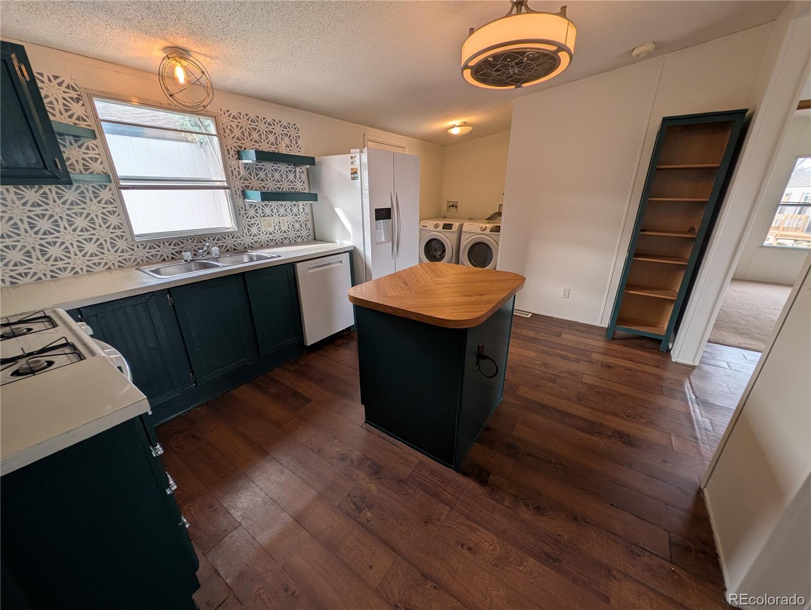 17190 Mt Vernon Road Golden, CO 80401 - Photo 24 of 29 a kitchen with stainless steel appliances granite countertop a sink stove and refrigerator