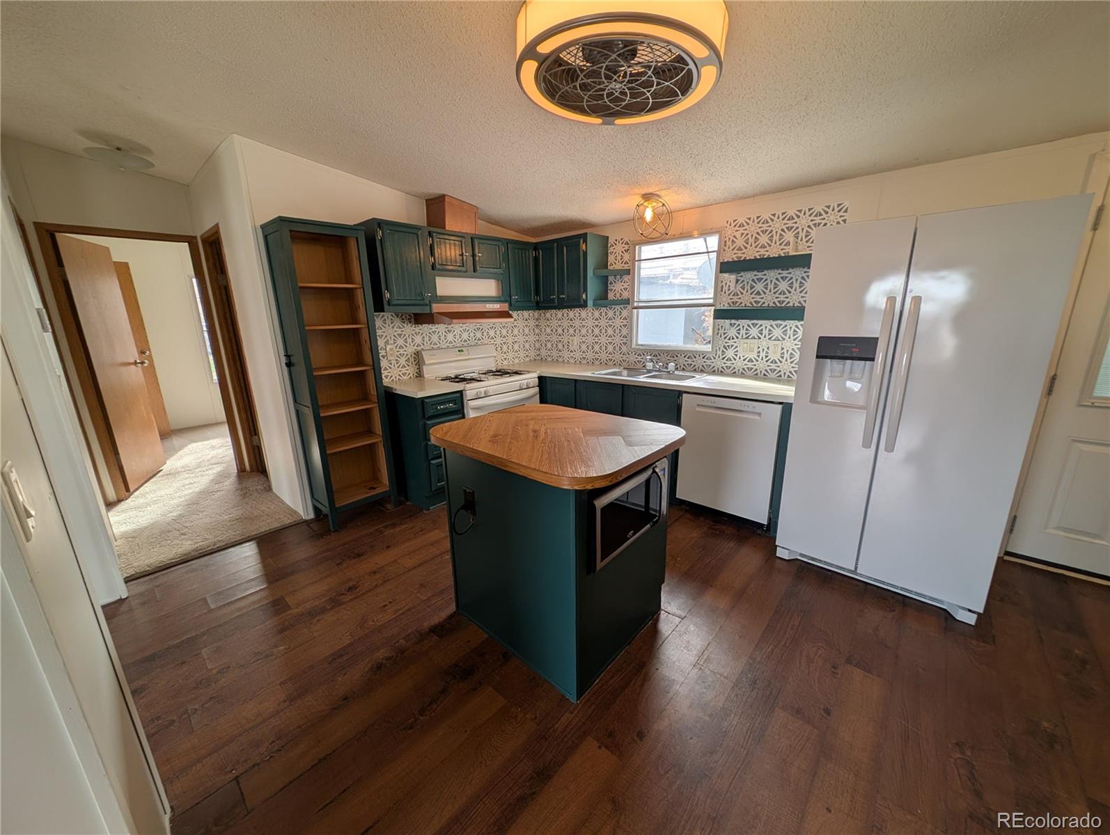 17190 Mt Vernon Road Golden, CO 80401 - Photo 25 of 29 a kitchen with stainless steel appliances granite countertop a refrigerator a stove a sink and a stove