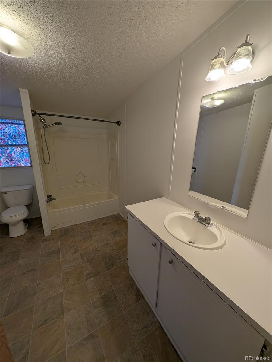 17190 Mt Vernon Road Golden, CO 80401 - Photo 10 of 29 a bathroom with a sink and a mirror