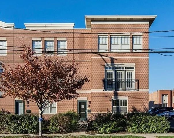 front view of a house with a tree