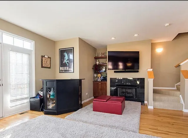 a living room with furniture a flat screen tv and a fireplace