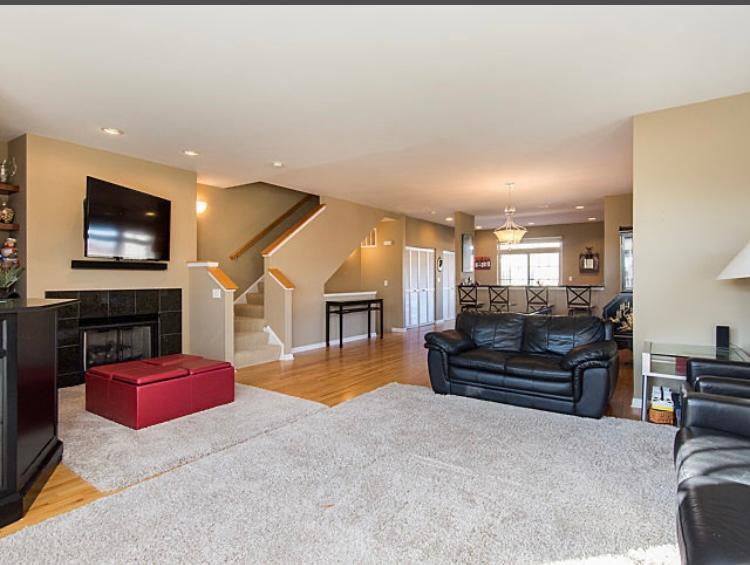 7426 West Fullerton Avenue Elmwood Park, IL 60707 - Photo 14 of 20 a living room with furniture and a flat screen tv with kitchen view