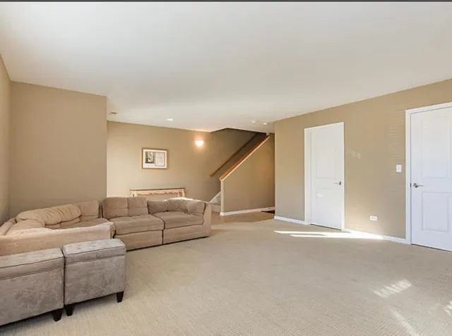 a living room with furniture and a ceiling fan
