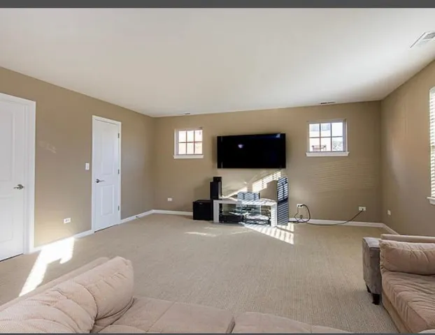 a view of a livingroom with furniture and windows