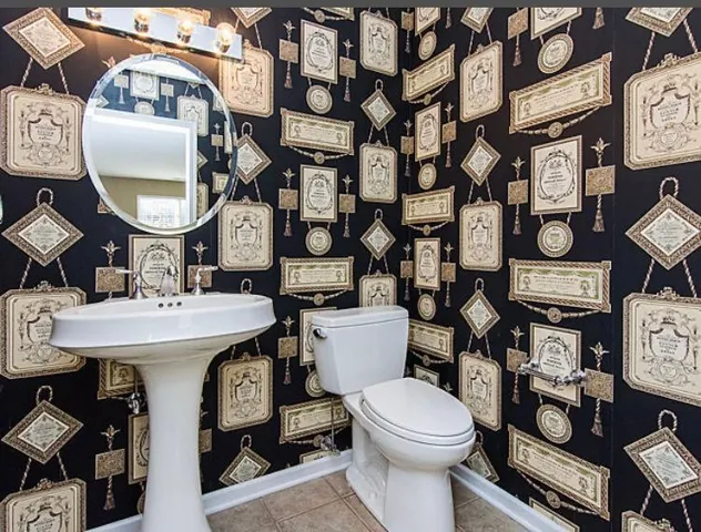 a bathroom with a sink toilet and a mirror