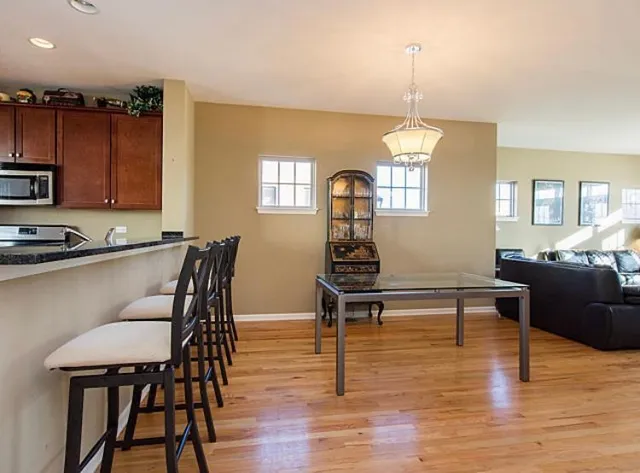 a living room with furniture dining table and a window
