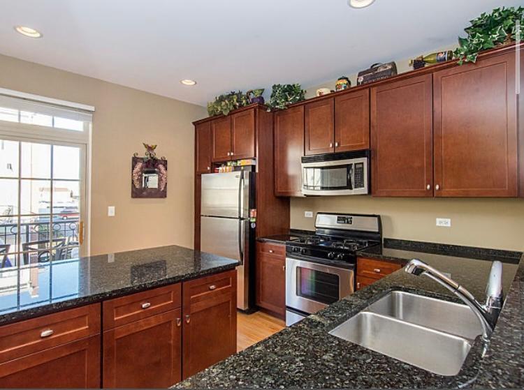 7426 West Fullerton Avenue Elmwood Park, IL 60707 - Photo 8 of 20 a kitchen with granite countertop stainless steel appliances a sink stove refrigerator and cabinets