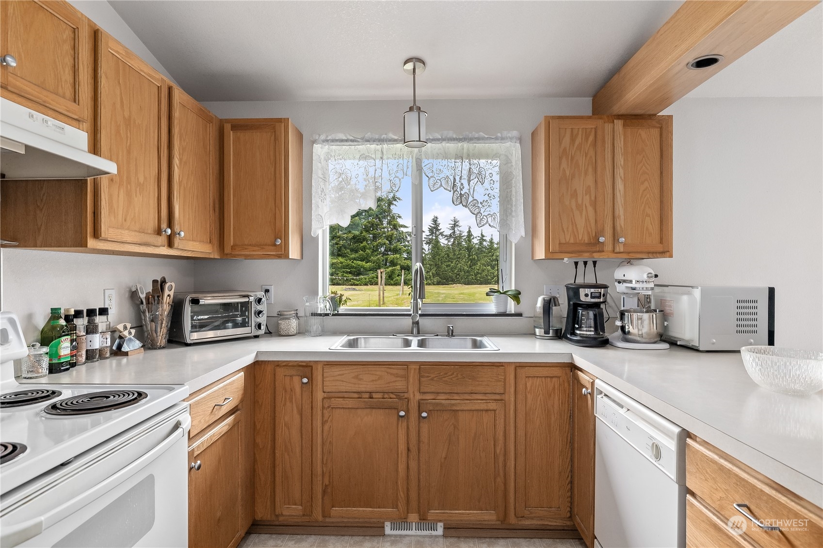 10532 School Land Road Southwest Rochester, WA 98579 - Photo 13 of 23 a kitchen with a sink and cabinets