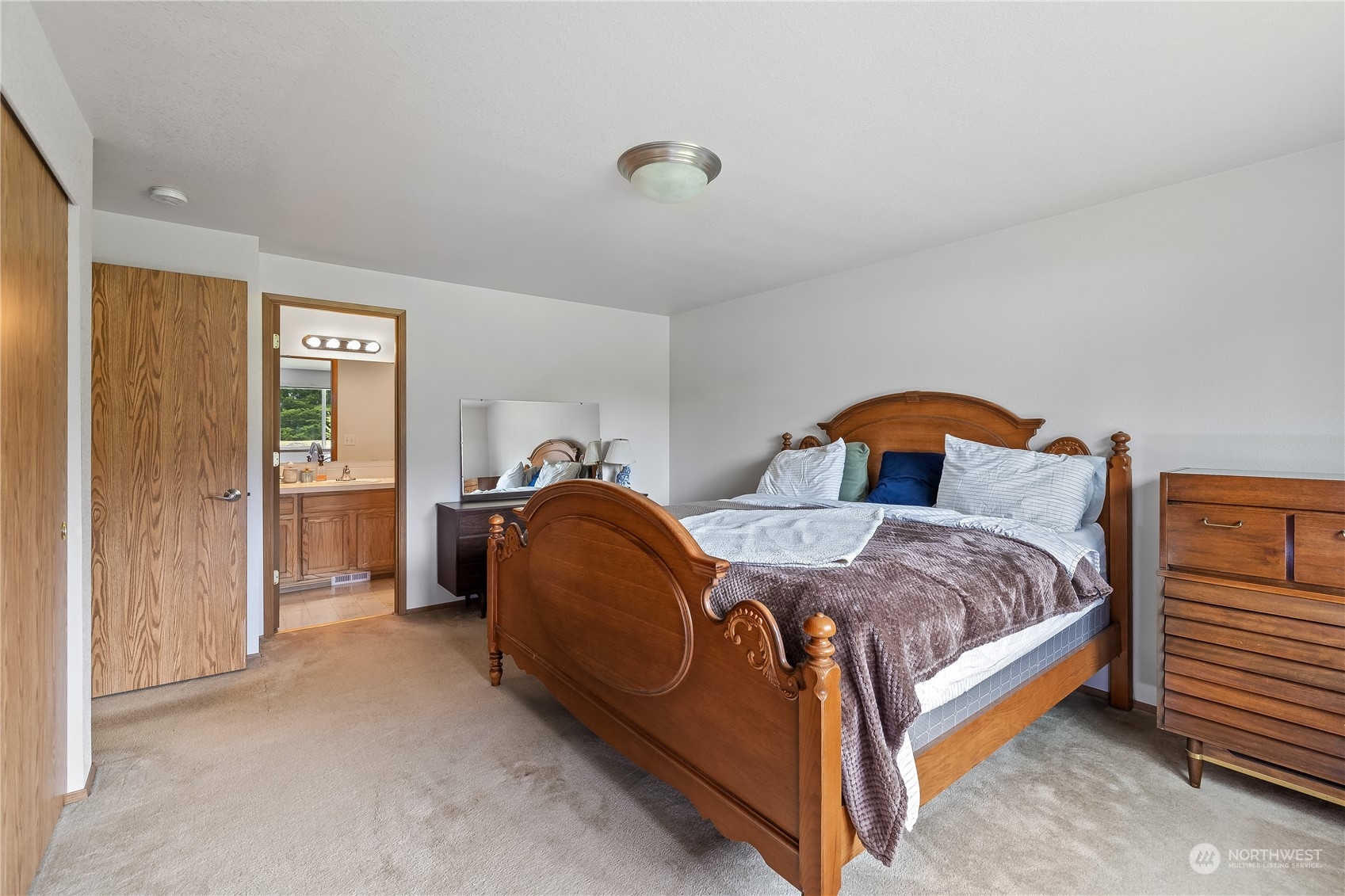 10532 School Land Road Southwest Rochester, WA 98579 - Photo 16 of 23 a spacious bedroom with a bed and a window
