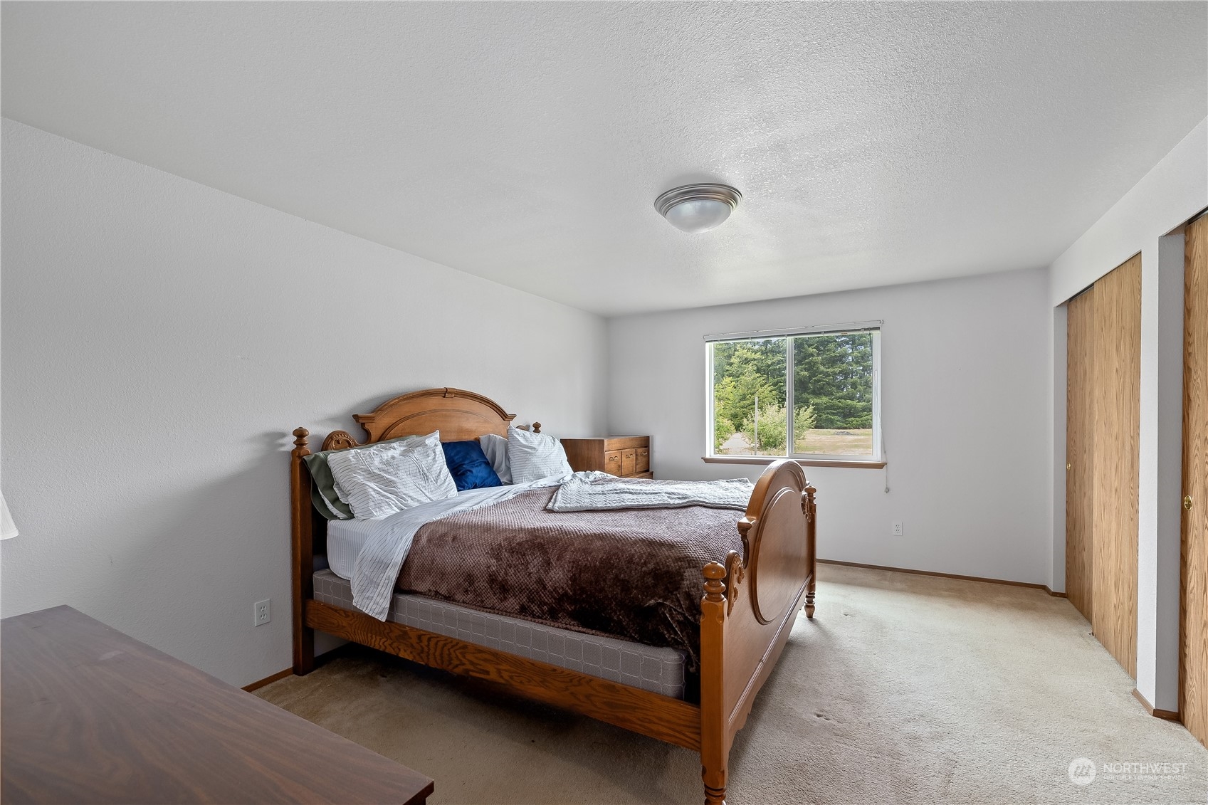 10532 School Land Road Southwest Rochester, WA 98579 - Photo 17 of 23 a bedroom with a bed and a window